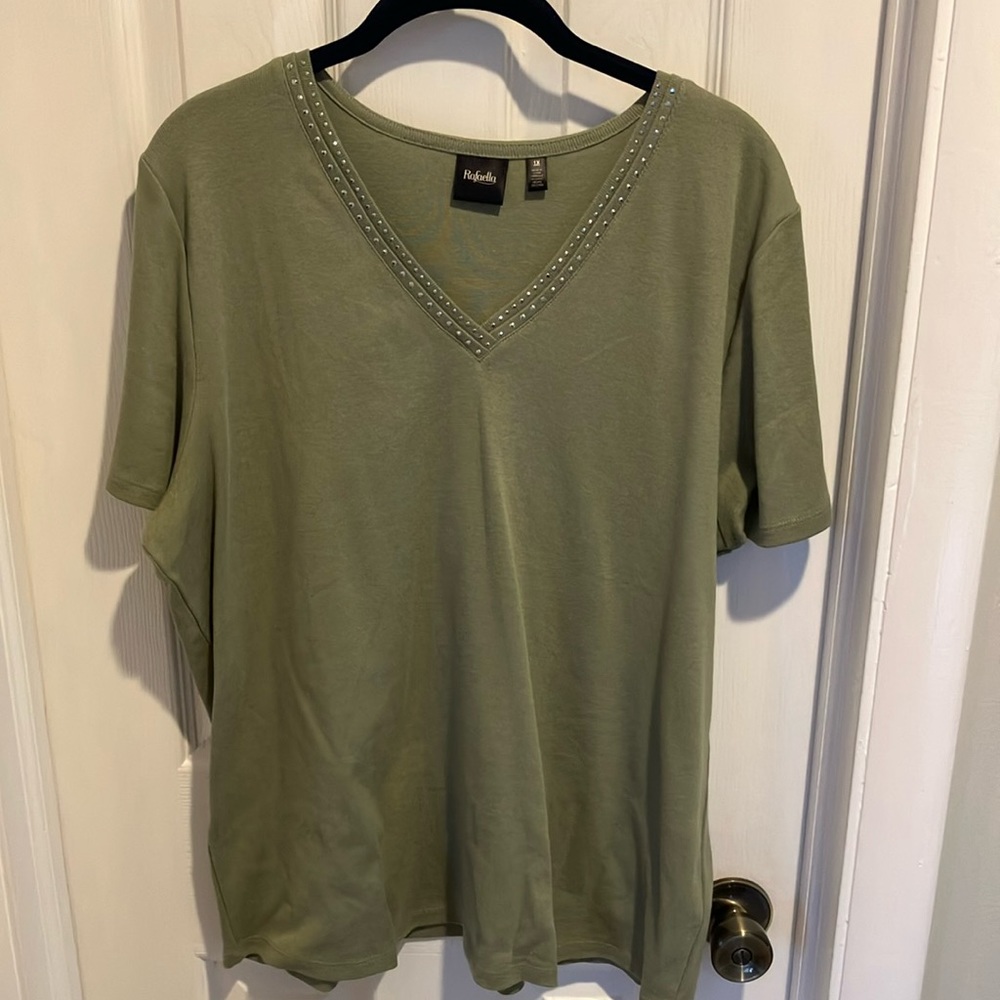 Short-sleeved knit top in light olive with metal embellishment.
